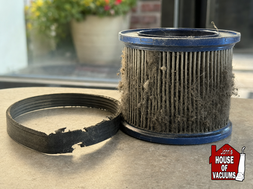 Worn vacuum belt and clogged filter shown side by side